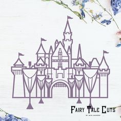 a paper cut out of a fairy tale castle with blue flowers in the foreground