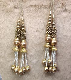 Indian Handmade Latkan for Saree Blouse Lehenga HandBags Dupatta Decoration Bridal Tassel Wedding dress for Women pair of 2 pcs Size - 18.0 cm Length  Item Description You can use this Beautiful pair of tassle for several DIY projects.  *These beautiful Tassel Latkans are used as the accessory for saree blouse on the back, but u can use according to your need and your innovative ideas. * Package contains 2 Latkan / 1 Pair Other Than Saree Blouse, you can use these latkans in various ways Craft Projects Designing Home Decoration Festive celebrations. Evening and party Apparels. Home décor items Apparel & Fashion Scarves n Stoles Headband, hats Table cover, curtains, Pillow covers, Cushion cover Shoe designing Headband, hats Table cover, curtains Designing stylish blouses Ship From New Delhi Tassel Wedding Dress, Wedding Dress For Women, Sari Lehenga, Blouse Lehenga, Stylish Blouses, Fashion Scarves, Innovative Ideas, Stylish Blouse, Table Cover