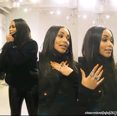 two women standing in front of a mirror talking on their cell phones while wearing black clothing