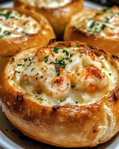 baked bread with shrimp and cheese in it on a white plate, ready to be eaten