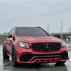 a red mercedes benz amg is parked in the parking lot