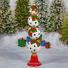 three snowmen are stacked on top of each other in front of christmas trees and presents