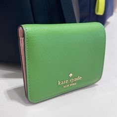 Kate Spade Madison Small Bifold Wallet Turtle Green Nwt Authentic Measurements 4.48" W X 3.8" H Features Metal Pinmount Logo Closure Type: Flap With Magnetic Snap Closure, Flap With Mag Snap Closure Dust Bag Included: No Exterior: Back Slip Pocket Materials Saffiano Leather Lining: Two Way Script Logo Lining Imported Style Number Kc581 Ksny Editor's Notes Don't Let The Size Deceive You: Our Small Wallets Have Room For All Your Credit Cards And Cash. Plus, You Can Fit It In Your Tiny Bag. Compact Kate Spade Wallets For Travel, Compact Green Wallet With Card Slots, Green Rfid Blocking Coin Purse For Travel, Compact Green Wallet For Travel, Compact Green Travel Wallet, Compact Kate Spade Wallet, Kate Spade Pink Bifold Wallet, Compact Kate Spade Coin Purse, Tiny Bag