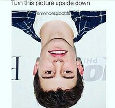 a man is upside down on the ground with his head tilted to the side and eyes wide open