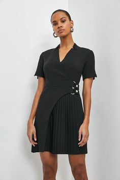 This dress is full of unexpected touches. Proving that it’s all in the details, the piece features an elegant notched collar, buckled detail at the waist (that’ll cleverly draw the eye in) and a cut-out pleated panel that’ll move as beautifully as you. Black Fitted V-neck Belted Dress, Black Belted Midi Dress For Semi-formal Occasions, Tailored Mini Dress For Formal Occasions, V-neck Pleated Waist Dress For Work, Formal V-neck Pleated Dress With Pleated Hem, Tailored Structured Mini Dress For Work, Chic Semi-formal Belted Mini Dress, Dressy A-line Mini Dress For Work, Belted Fitted Office Lady Dresses