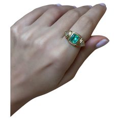 This exquisite 18-karat gold ring is centered with a natural emerald and paired with two natural trillion-cut diamonds, in a geometric stepped setting. The ring weighs just over 6grams of gold, giving it a luxurious feel. It's three stone design is timeless, and the setting of the stones allows the wearer to enjoy it on the daily as the stones are protected due to their bezel style setting. The Emerald is 1.50cts and the diamonds are 0.25cts each (Color G, Clarity VS/SI). This ring has been made in Cyprus, and can be resized to your desired size. If you would like to receive more photos or videos of this ring simply drop us a message and we will gladly forward these to you. We ship complimentary using DHL Express all across the world. Fine Jewelry Green Signet Ring With Birthstone, Green Emerald Signet Ring With Birthstone Detail, Green Emerald Signet Ring Fine Jewelry, Yellow Gold Emerald Diamond Ring With Vvs Clarity, Green Diamond Ring With Vvs Clarity In 14k Gold, Green Emerald Signet Ring For Wedding, Heirloom Green Diamond Ring With Baguette Cut, Heirloom Green Diamond Ring Baguette Cut, Gia Certified Emerald Cut Green Rings