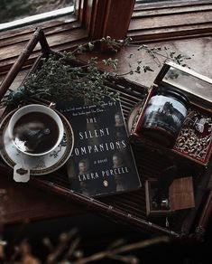 a cup of coffee and some books on a table