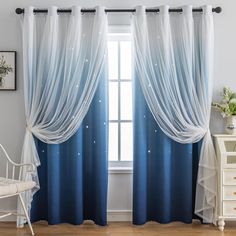 the curtains in this room are blue and white with stars on them, as well as sheer drapes