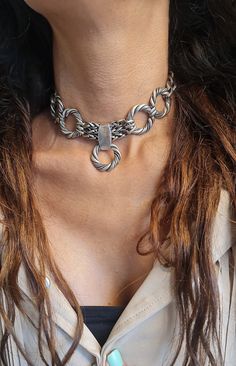 ◾ A beautiful and striking choker necklace made of silver-plated brass.    The necklace is adorned with round, twisted hoops, a foxtail chain, and a curb chain, making it suitable     For both evening and morning events. ◾   SIZE Length: 11.8IN (30cm) up to 16.5IN (42cm)       Width Hoop:  0.98IN(2.5cm).      Width curb: 0.39IN (1cm) thick chain: 0.19IN (5mm)      In addition to the length of the chain, there is an extension chain of 2.36IN (6cm) ◾   You can see a similar choker at this link:  ◾  NEW!  oxidized Chain bold necklace, Large circle Hoop necklace, Statement Chunky Necklace, large      Unique Choker collar, Edgy O ring Choker ◾  The shipment is in the registered mail including a tracking number.  ◾  This piece of jewelry is perfect as a gift for yourself, for a wedding day, Vale Thick Choker, Edgy Rings, Unique Choker, Chunky Silver Necklace, Hoop Necklace, O Ring Choker, Chain Collar, Chain Making, Silver Choker Necklace