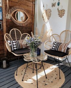 two wicker chairs sitting on top of a wooden floor next to a coffee table