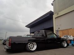 a black truck parked in front of a building