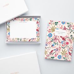 three personalized notepads in a box with floral designs on the front and back