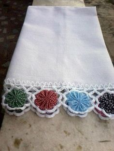 an embroidered table runner with flowers on it