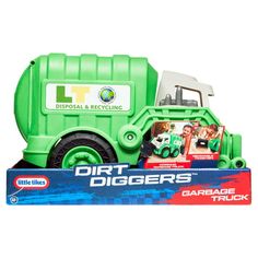 a green garbage truck is in the box