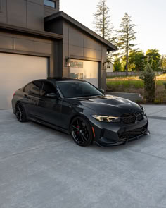 a black car parked in front of a garage