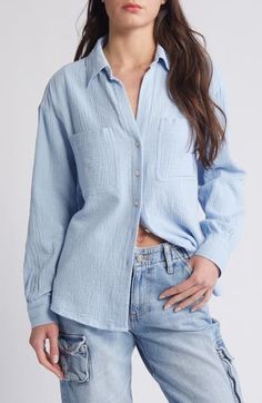 This all-cotton button-up shirt is subtly textured to give off casual vibes. 28" length (size 8) Front button closure Spread collar Long sleeves 100% cotton Machine wash, line dry Imported Casual Cotton Blouse With Button Closure, Summer Cotton Tops With Buttoned Pockets, Light Blue Cotton Top With Placket, Light Blue Cotton Tops With Placket, Summer Cotton Blouse With Buttoned Pockets, Light Blue Cotton Tops With Buttons, Trendy Cotton Button-up Blouse, Cotton Button-up Blouse With Buttoned Pockets, Cotton Blouse With Buttoned Pockets, Relaxed Fit