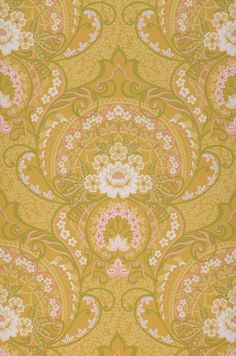 an ornate yellow and pink wallpaper with white flowers on the bottom half of it