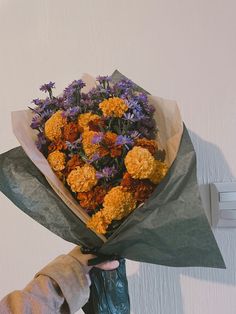 a person holding a bouquet of flowers in their hand