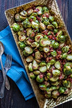 a pan filled with brussel sprouts on top of a wooden table