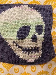 a crocheted square with a skull on it