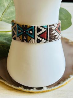 The adorable Aztec print leather cuff bracelet. Made in the USA. This bracelet is the perfect accessory for any womens wardrobe.  This bracelet is a great womens gift. Due to the assorted nature of this item, unique variations in color and print yield one-of-a-kind bracelet. The bracelet you receive may vary in style, print, and color from what is pictured. Adjustable Multicolor Cuff Bracelet, Adjustable Leather Bangle Bracelet For Festivals, Adjustable Southwestern Cuff Bracelet, Southwestern Adjustable Cuff Bracelet, Trendy Cuff Leather Bracelet Gift, Trendy Cuff Leather Bracelet As Gift, Trendy Leather Cuff Bracelet For Gift, Southwestern Adjustable Leather Bracelet Gift, Southwestern Adjustable Leather Bracelet