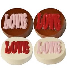 three chocolate candies with the word love painted on them