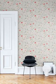 an empty room with a chair and wallpaper