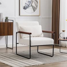 a white chair sitting on top of a hard wood floor next to a wooden table