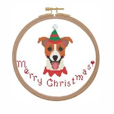 a cross stitch dog with a christmas hat on it's head