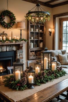 a table topped with candles next to a fire place filled with christmas wreaths and pine cones