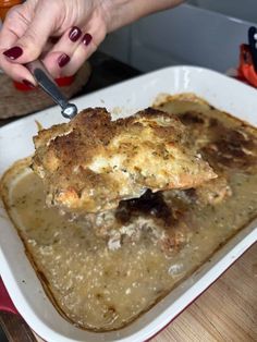 a person is cutting into some food in a pan