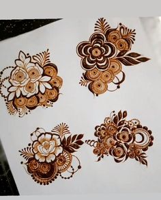 hendi tattoos on the back of a sheet of paper with flowers and leaves painted on them