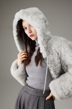 Embrace Winter Warmth: Chic Hooded Shearling for Effortless Elegance ( Pre-sale - Expected to ship out within 7-10 days ) Our Fluffy Crop Shearling Teddy Coat with Hood is the epitome of winter comfort and style. Made from imported shearling, this coat blends exquisite luxury with a casual, sophisticated aesthetic. Its plush, soft texture gives a feeling of warmth and comfort, akin to a cozy embrace. Its inclusive design fits all body types, effortlessly complementing any outfit. The hooded desi Fitted Sheepskin Fur Coat For Winter, Fitted Shearling Fur Coat For Winter, Winter Sheepskin Fur Coat With Faux Fur Lining, Faux Fur Coat With Detachable Hood, Luxury Chic Fluffy Outerwear, Winter Shearling Fur Coat With Faux Fur Trim, Fluffy Hooded Cozy Outerwear, Hooded Sheepskin Fur Coat With Faux Fur Trim, Hooded Shearling Fur Coat With Faux Fur Trim