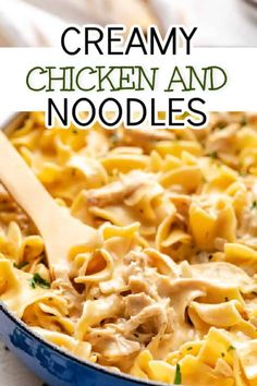 creamy chicken and noodles in a blue skillet with a wooden spoon on the side