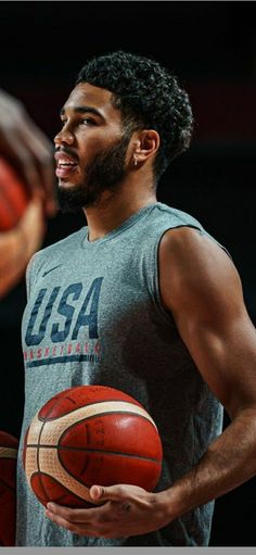 a man holding a basketball in his hands