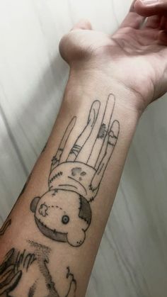 a person's arm with a tattoo on it that has a monkey holding something in the air