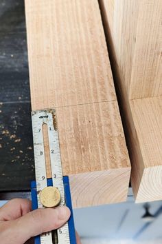 a person measuring wood with a ruler