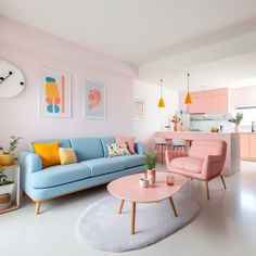 a living room filled with furniture and pink walls