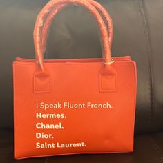 Orange, I Speak Fluent French Handbag Product Details: 100% Vegan Leather Magnetic Clasp Dimensions: 7.5” X 9.5” X 3.0” Handles: 5.5” Wide X 4.5” High Removable Strap Chic Orange Bag With Double Handle, Elegant Orange Double Handle Bag, Rectangular Orange Bag With Handles, Modern Orange Rectangular Bag, French Handbags, Orange Tote Bag With Gold-tone Hardware, Orange Handbag, Mini Moderns, Tangerine Orange