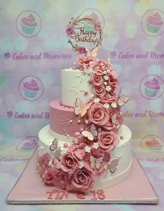 a three tiered cake with pink flowers and butterflies on the top is displayed in front of a backdrop