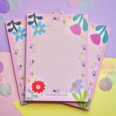 three papers with flowers on them sitting next to confetti circles and polka dots