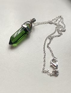 Bright spring green glass point pendant on 16 inch silver chain with lobster clasp. Comes in a pretty  organza bag with a little fairy charm. A gift label can be created, please request when ordering, the item can be sent to you or posted as a gift direct to the recipient. All items are sent 2nd class Royal Mail, within 1-2 days of ordering. First class upgrade available Green Sterling Silver Charm Necklace With Lobster Clasp, Green Sterling Silver Charm Necklace With Round Pendant, Handmade Green Sterling Silver Charm Necklaces, Green Nickel-free Pendant Charm Necklace, Green Sterling Silver Charm Necklace For May Birthstone, Silver Crystal Necklace For May Birthstone Gift, Silver Crystal Necklace For May Birthstone, Green Pendant Crystal Necklace Nickel Free, Green Wire Wrapped Necklace For Gift