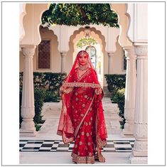 a woman in a red bridal outfit