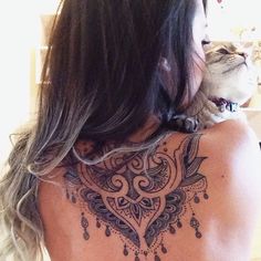 a woman with a cat on her back