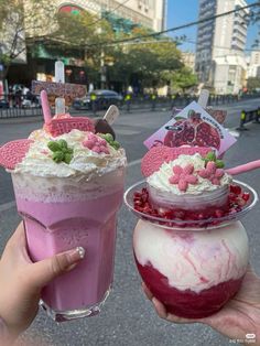 two people holding up drinks in their hands