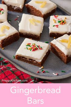 gingerbread bars with white frosting and sprinkles are on a plate