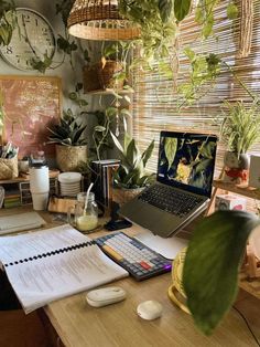 a laptop computer sitting on top of a wooden desk