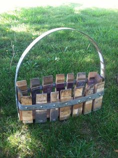 a basket made out of wooden blocks sitting in the grass