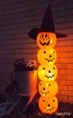 lighted pumpkins stacked on top of each other