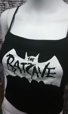 This is a black The Batcave crop tank top with spaghetti straps. This has a Batcave image screen printed on the front. 57% cotton/ 38% polyester/ 5% SpandexThese are handmade screenprinted and slightly vary from the photo. Please feel free to email me any questions. Thanks for looking.Due to an influx of incorrect addresses if a package is returned,  you must pay the shipping cost to resend the item to you.I do not do exchanges and I do not take returns unless the item is damaged. I thoroughly c Edgy Black Tank Top For Halloween, Punk Black Tank Top For Halloween, Punk Style Black Tank Top For Halloween, Fitted Black Crop Top Band Merch, Punk Sleeveless Cosplay Tops, Punk Sleeveless Tops For Cosplay, Fitted Black Emo Tank Top, Black Fitted Grunge Tank Top, Fitted Black Emo Style Tank Top